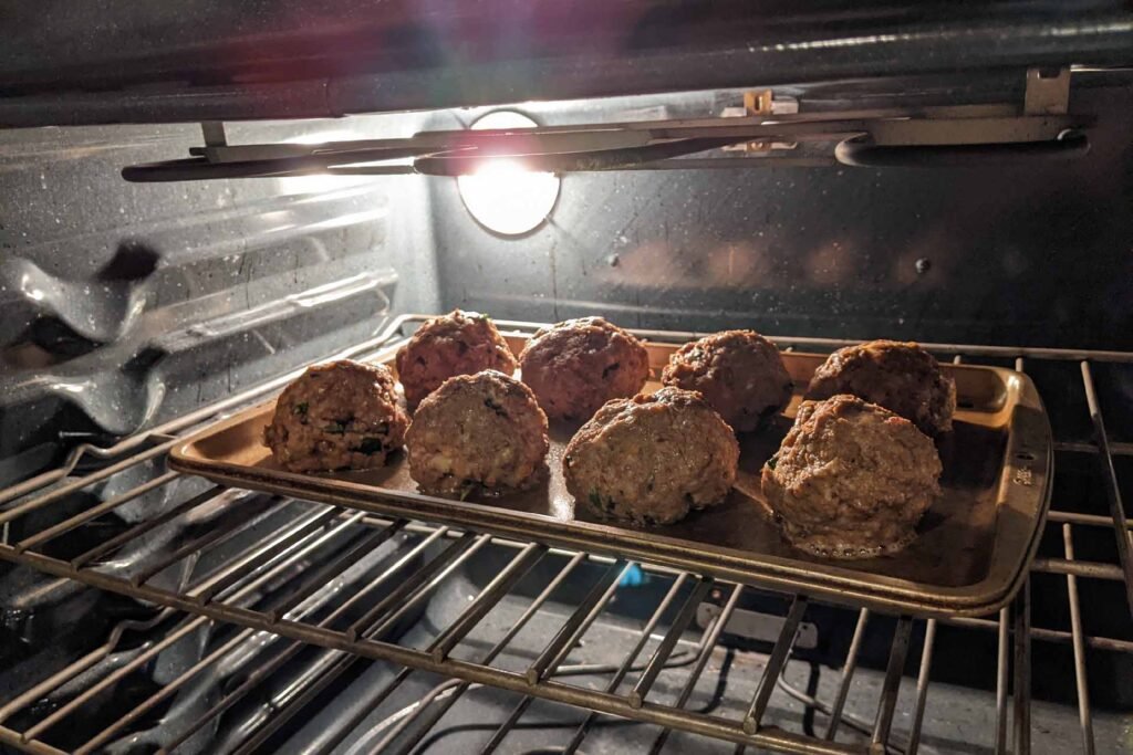 Meatballs baking in an oven