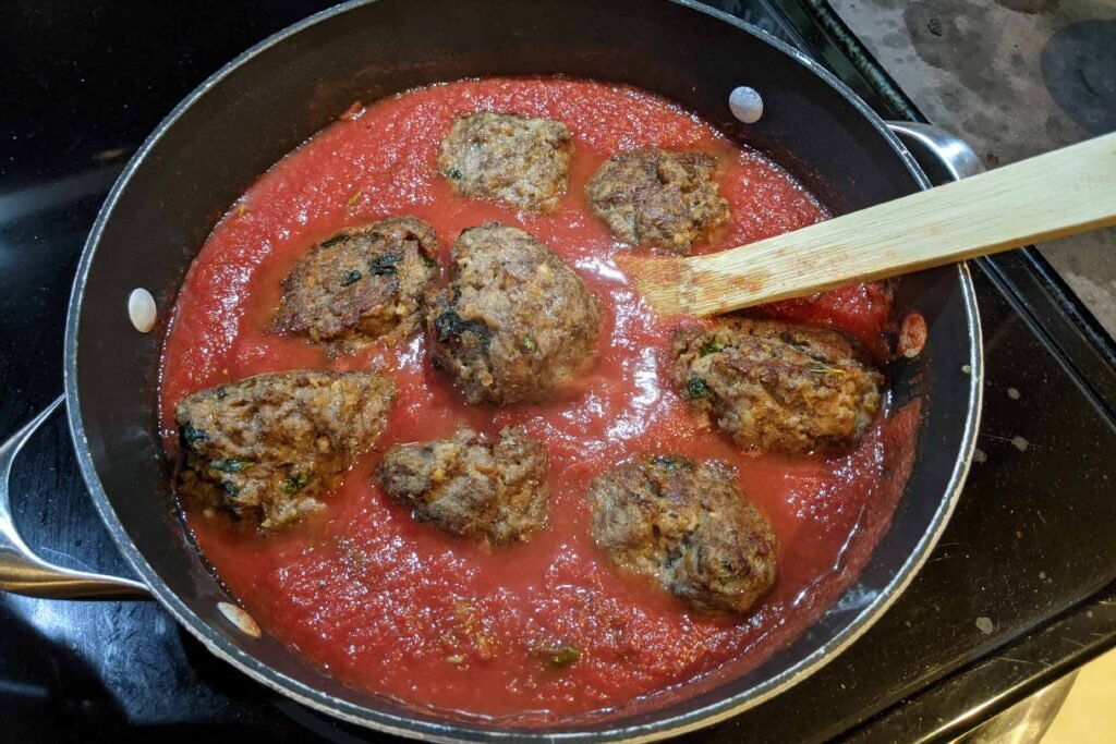 Meatballs in a pot of tomato sauce