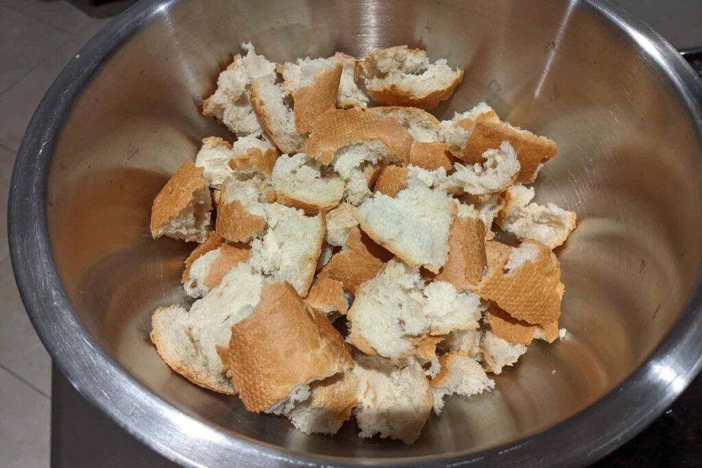 Mixing bowl filled with pieces of bread