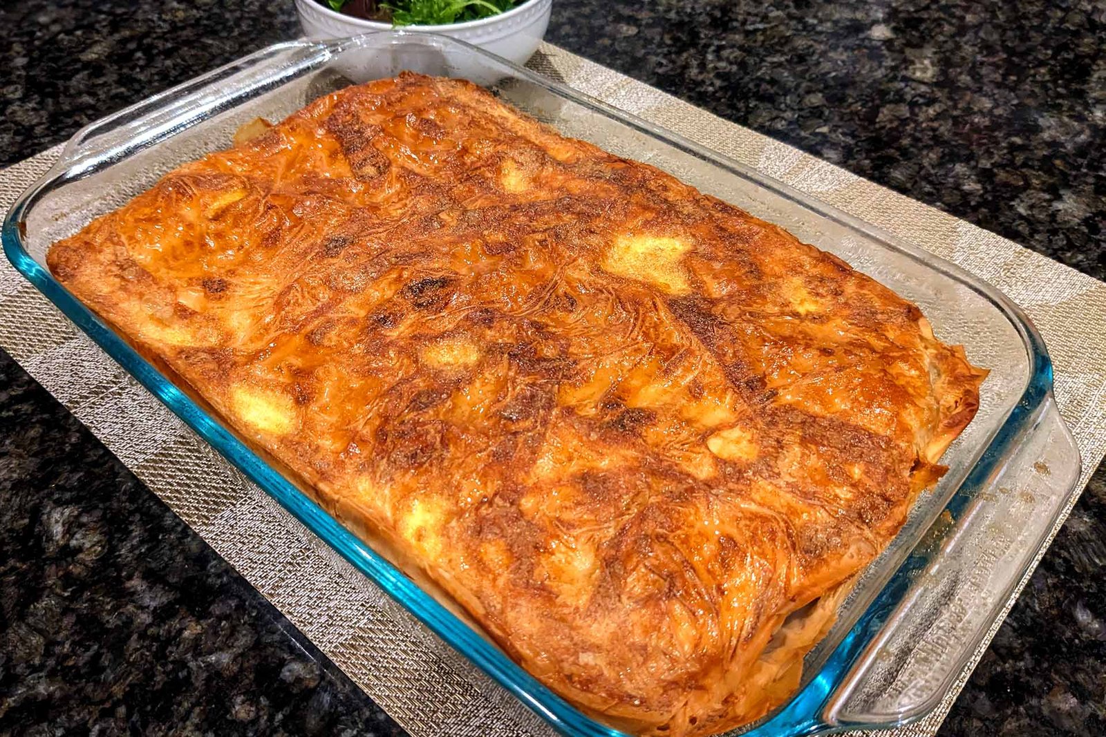 Golden brown Turkish Borek meat pie in a 13 inch by 9 inch baking dish