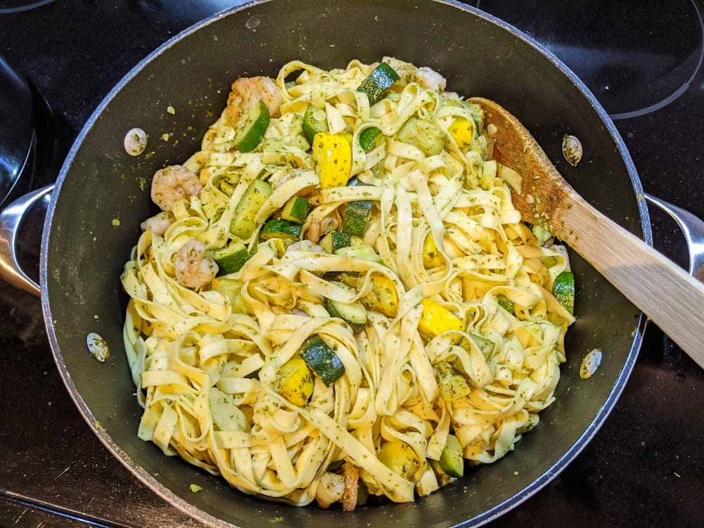 Fusilli Con Buco - Linguini pasta with zucchini and shrimp in a sauce pan