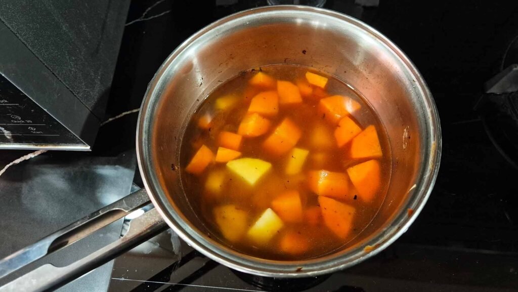 Stainless steel pot filled with curry mixture