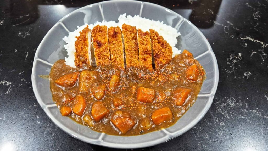 Plate of Katsu Curry with a side of pork Tonkatsu and white rice