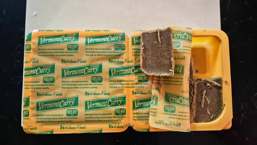 Cube of curry mix sitting on top of a package